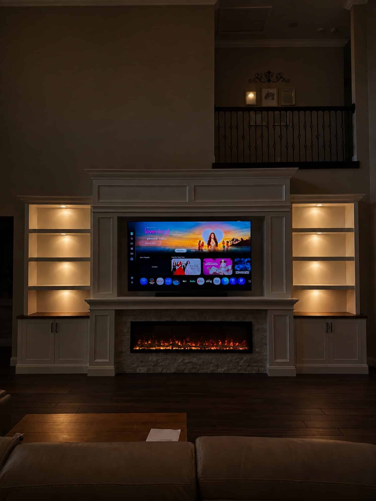 Orlando fireplace wall with illuminated built-ins Illuminated white built-in fireplace wall designed for an Orlando living room