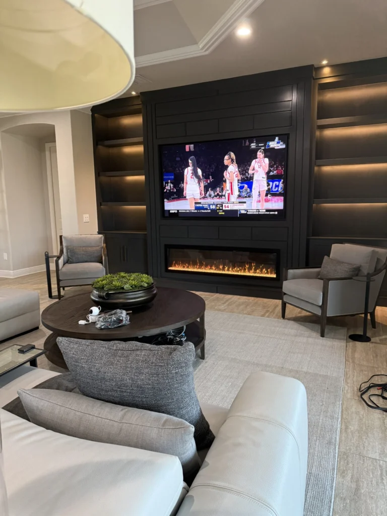 Dark entertainment wall with fireplace and accent lighting
