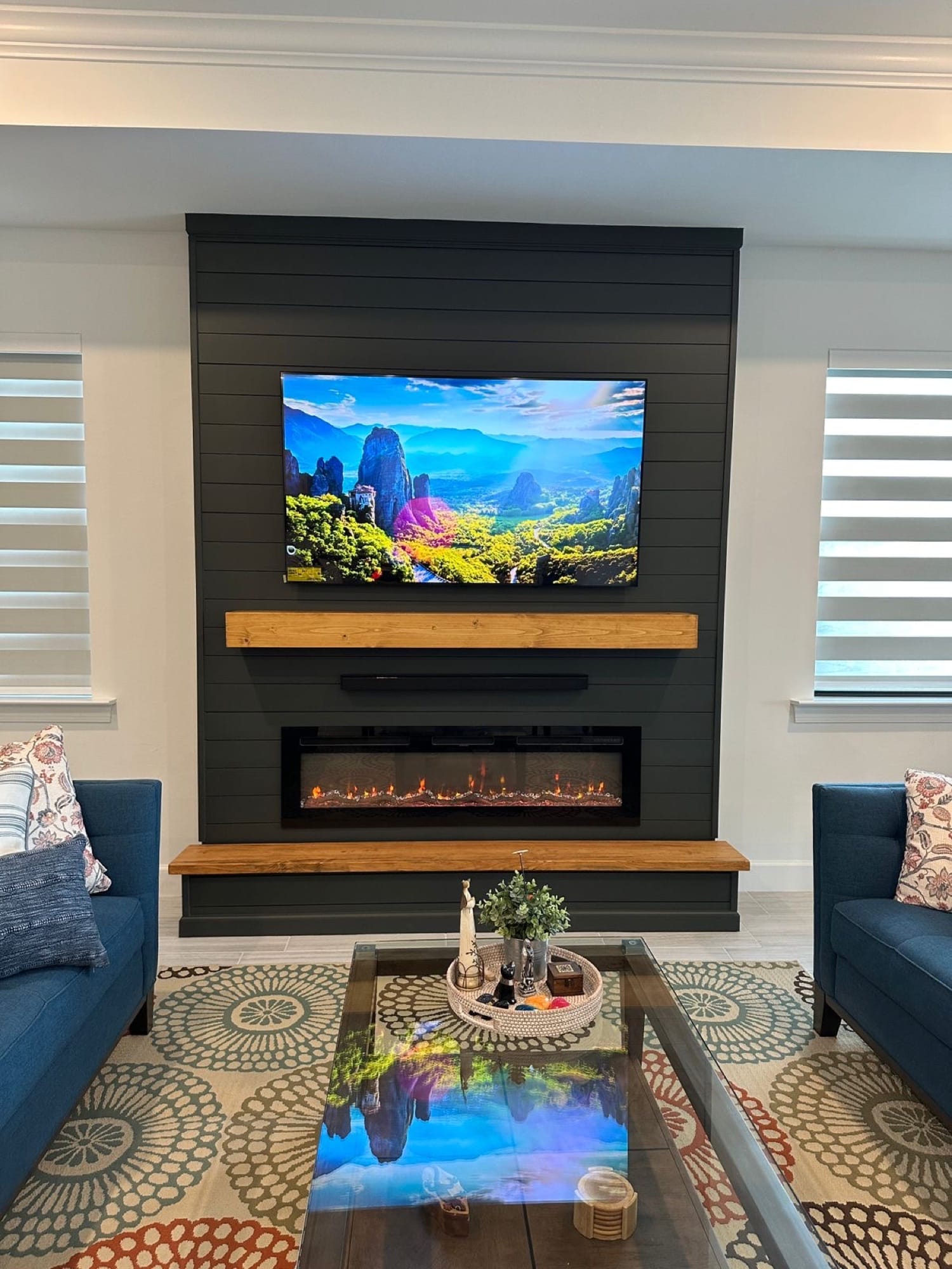 Dark shiplap fireplace wall with wood mantel and cabinetry for a Tampa home