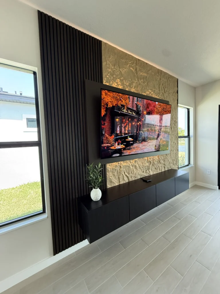 Modern TV wall showing layered stone texture and indirect lighting