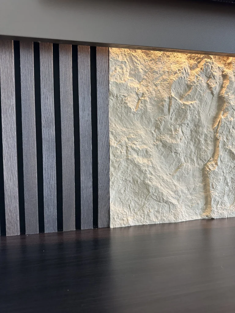 Close view of wood slat panel and textured media wall finish