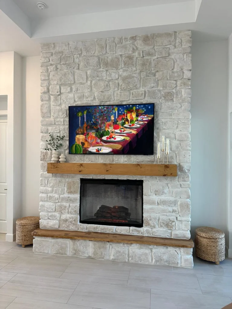 White stone fireplace and mounted television composition