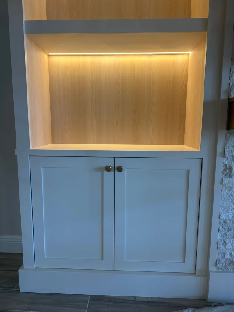 Illuminated display shelving with lower cabinets Custom white cabinet with warm LED display shelves