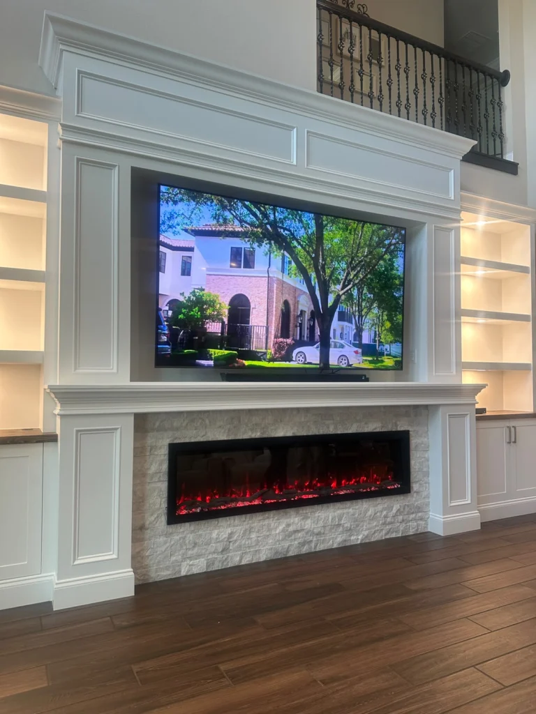 Traditional built-in cabinets and millwork Tall traditional fireplace wall with custom white built-in cabinets