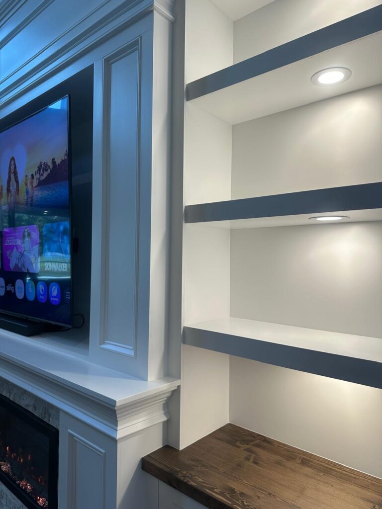 Illuminated built-in shelves with detailed crown molding