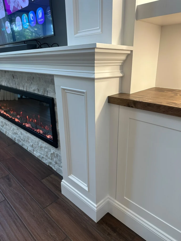 Traditional fireplace trim and stained wood countertop detail