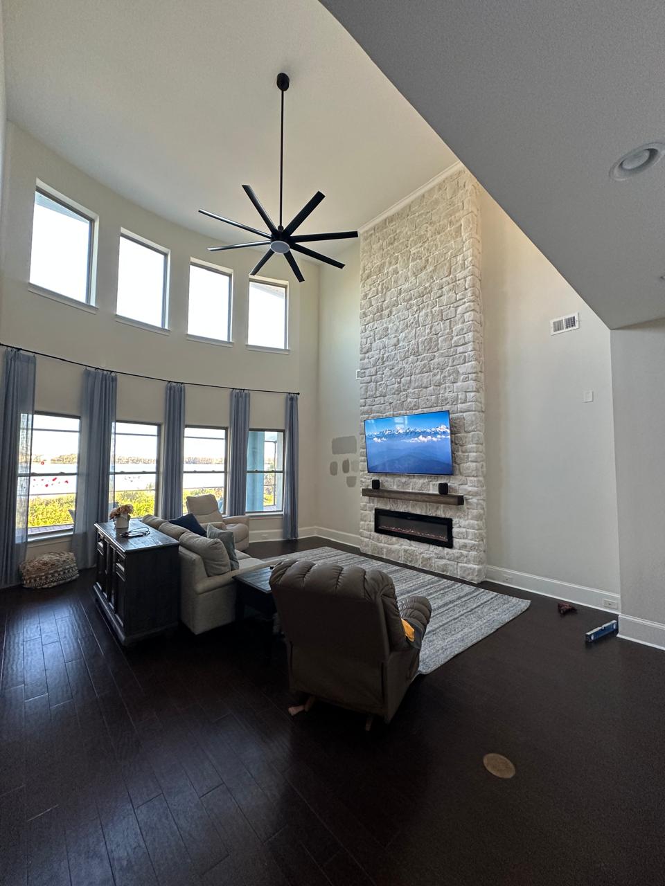 Double-height Florida living room with a 20-foot natural limestone fireplace wall